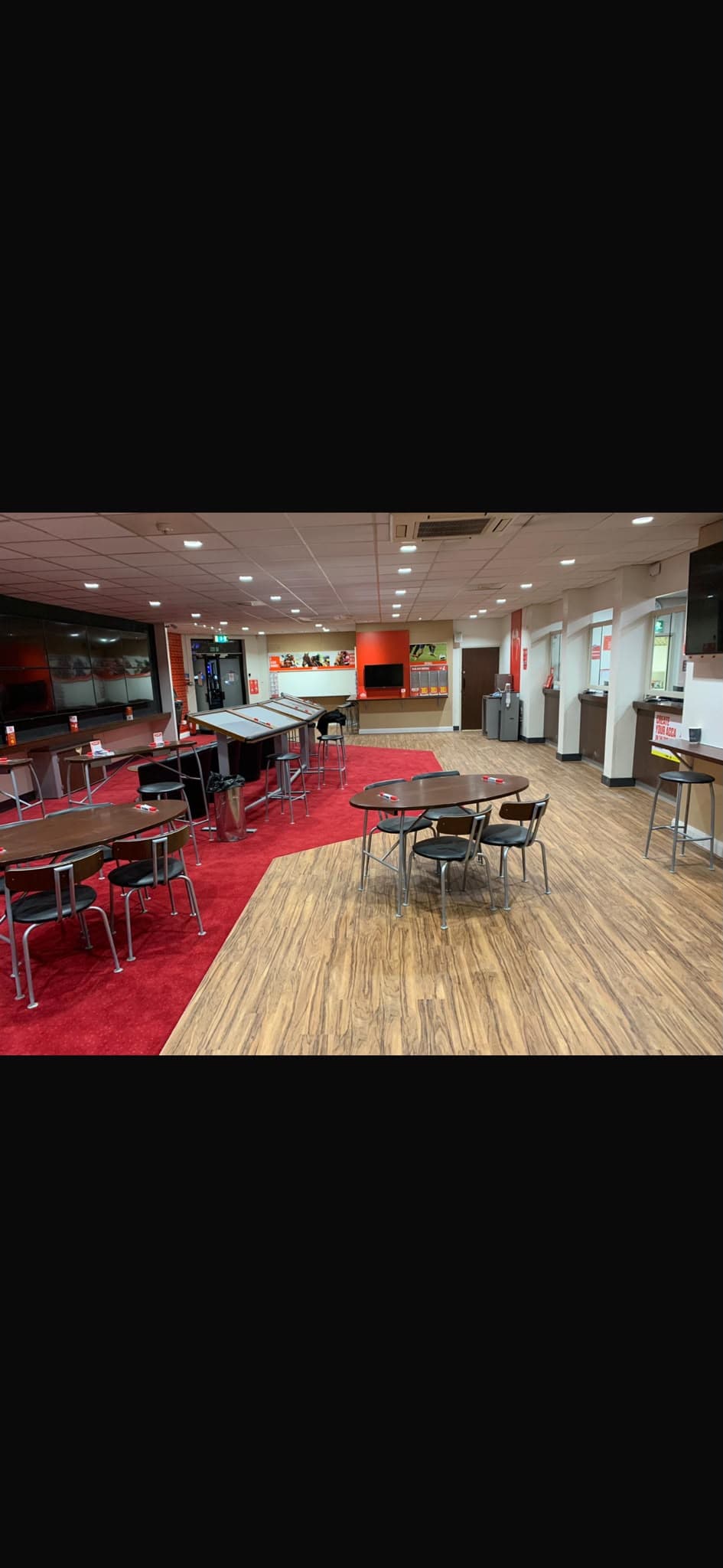 Wood-effect commercial vinyl flooring fitted across a betting shop customer area